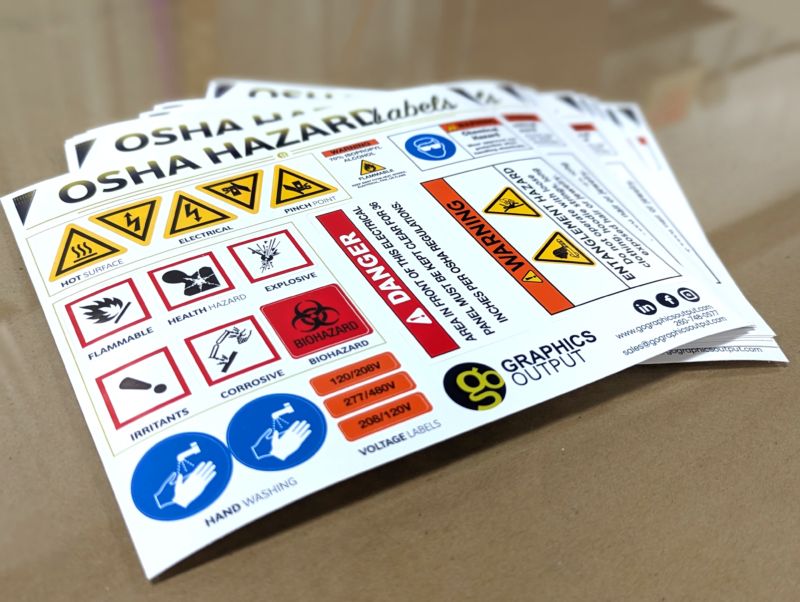 Label sheet of OSHA compliance safety decals including flammable icons, electrical box decals, pinch point warning decal, and biohazard decal